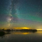 Meteor showers tonight with shooting stars over a lake at sunset.