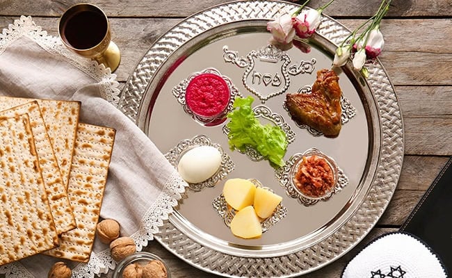 Seder dinner for Passover 2024 featuring matzo, gefilte fish, and other traditional Passover foods.