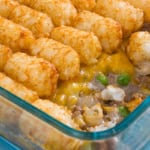 Tater tot casserole in a glass casserole dish.