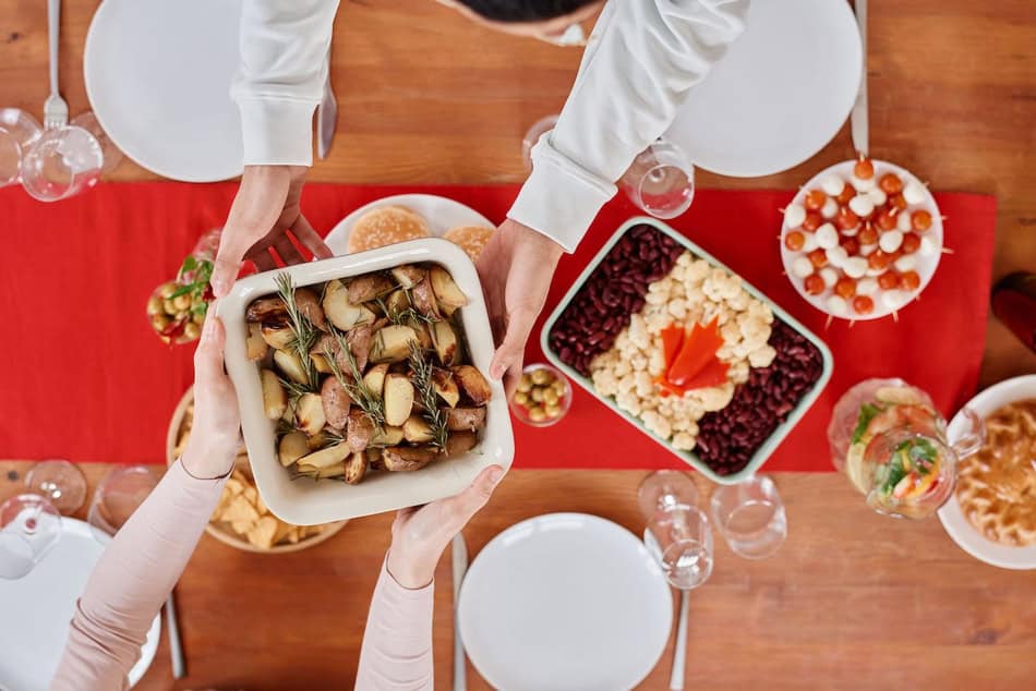 People sharing a delicious Thanksgiving meal with turkey and sides at a family gathering.