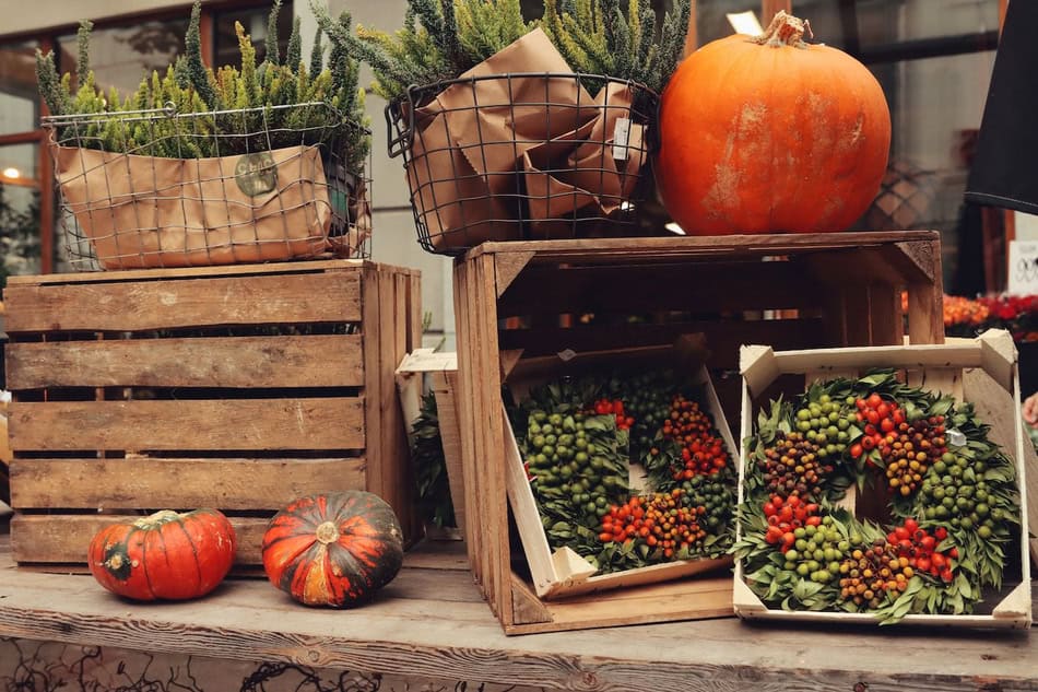 Fall pumpkins and harvest decorations for Halloween front porch.