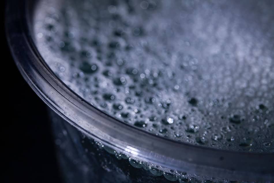 Close-up of boiling water with bubbles in a pot.