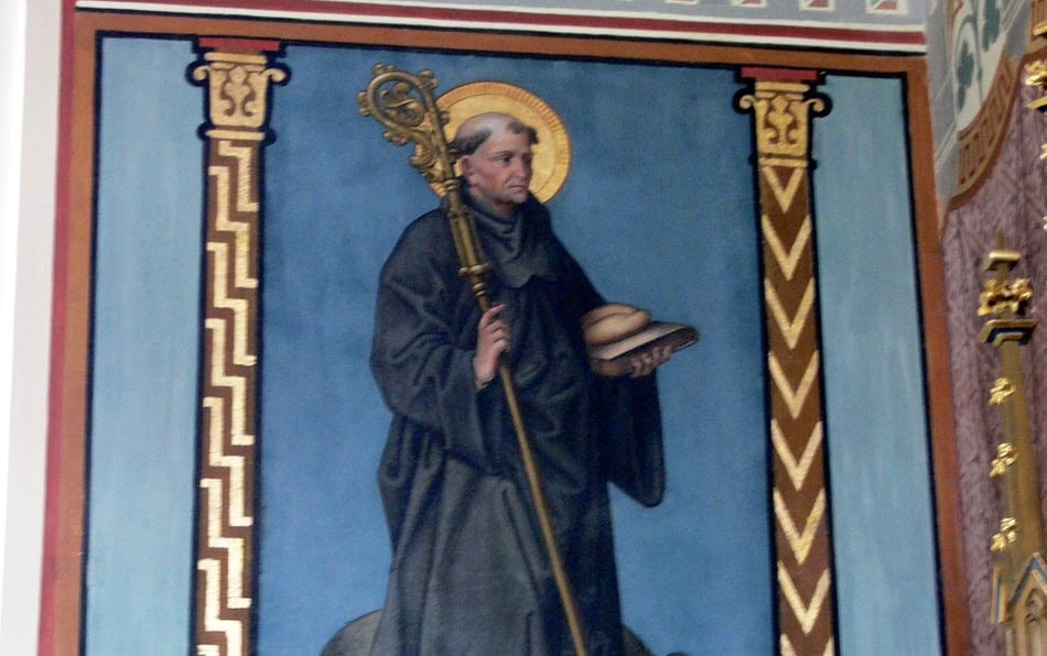 Religious fresco of a saint holding a key and a book in a church.