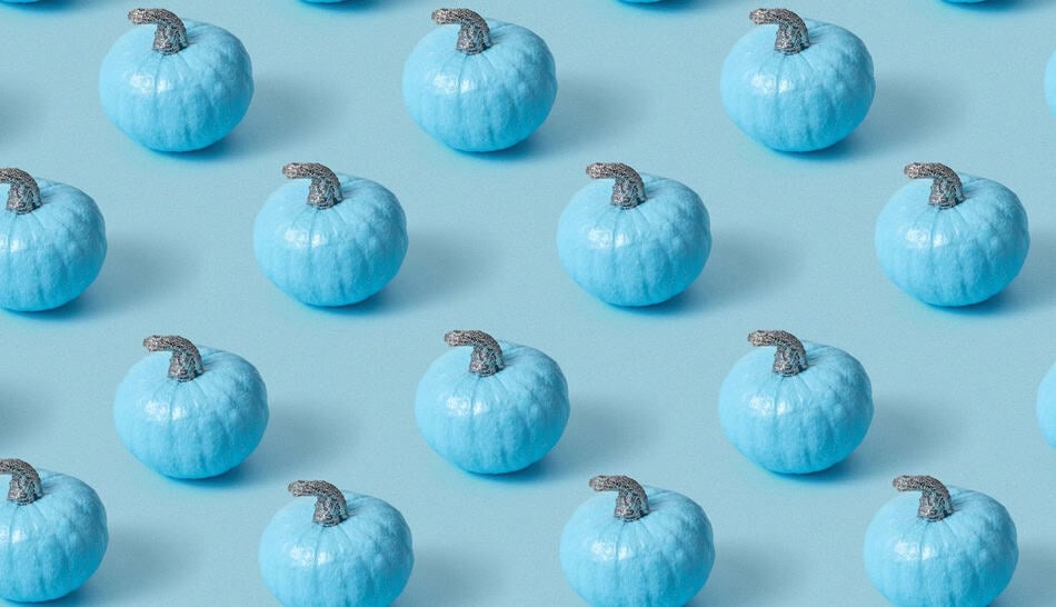 Multiple blue pumpkins with silver stems on a light blue background.