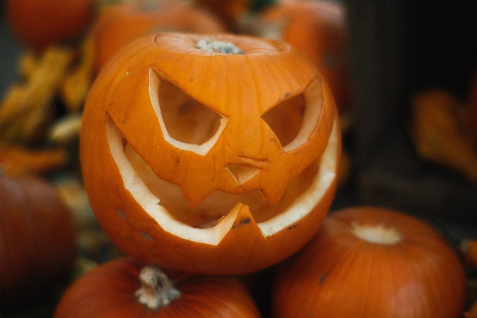 Carved pumpkin with a spooky face for Halloween decoration.